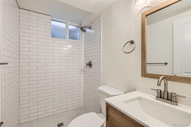 14317 Olmsted Dr, Denver, CO 80239 - bathroom featuring a stall shower, toilet, a textured wall, and vanity