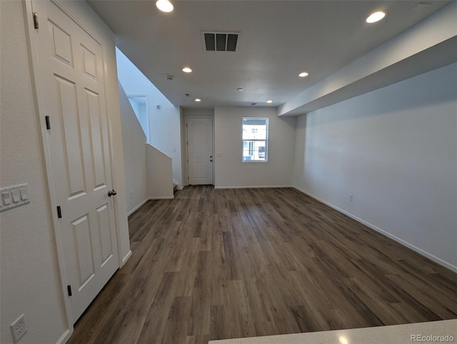 basement featuring dark hardwood / wood-style flooring