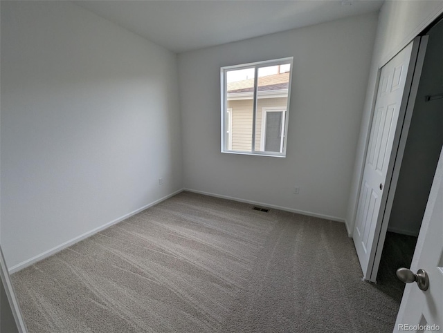 unfurnished bedroom featuring carpet floors and a closet