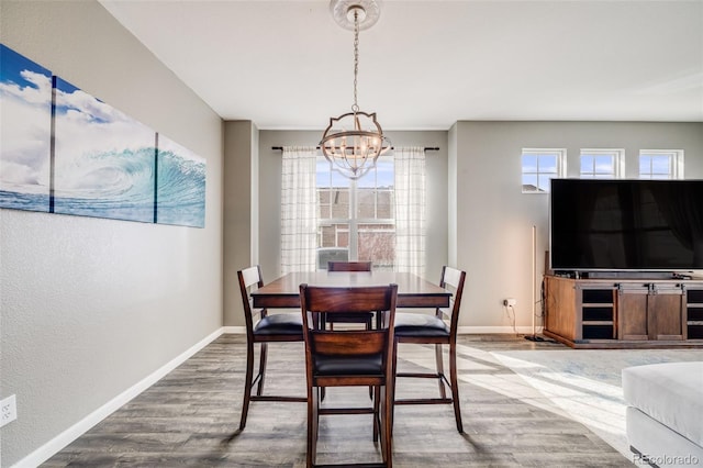 22765 E Ottawa Pl, Aurora, CO 80016 - dining space with a chandelier, wood finished floors, and a textured wall