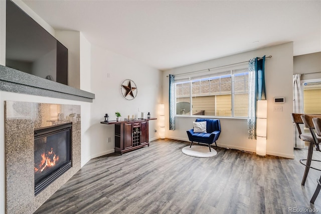 22765 E Ottawa Pl, Aurora, CO 80016 - living area with wood finished floors, a bar, and a tiled fireplace