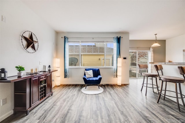 22765 E Ottawa Pl, Aurora, CO 80016 - living area featuring wood finished floors, a dry bar, and healthy amount of natural light
