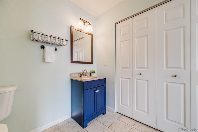 22765 E Ottawa Pl, Aurora, CO 80016 - bathroom featuring vanity, tile patterned flooring, and a closet