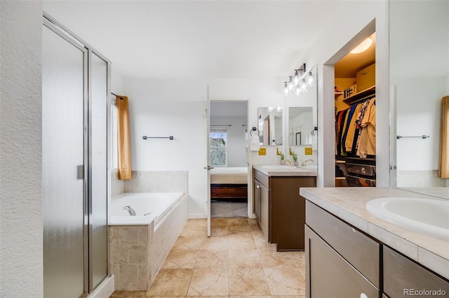 22765 E Ottawa Pl, Aurora, CO 80016 - full bathroom featuring two vanities, a stall shower, and a bath