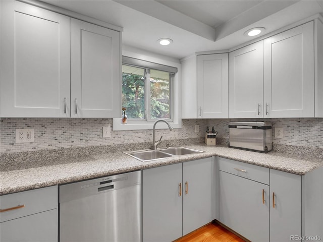 4720 W Stanford Ave, Denver, CO 80236 - kitchen with stainless steel dishwasher, recessed lighting, light countertops, white cabinetry, and tasteful backsplash