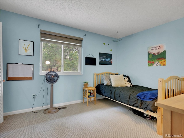 4720 W Stanford Ave, Denver, CO 80236 - carpeted bedroom featuring a textured ceiling