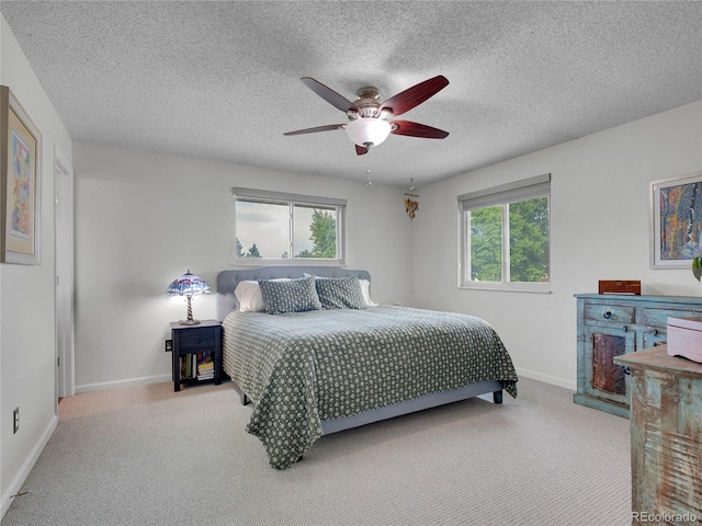 4720 W Stanford Ave, Denver, CO 80236 - bedroom featuring carpet flooring, multiple windows, a ceiling fan, and a textured ceiling