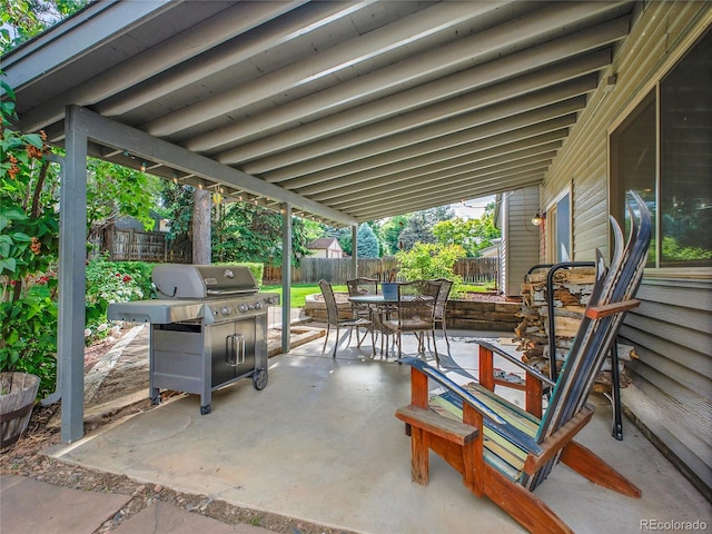 4720 W Stanford Ave, Denver, CO 80236 - fenced backyard featuring outdoor dining area, a patio, and a grill