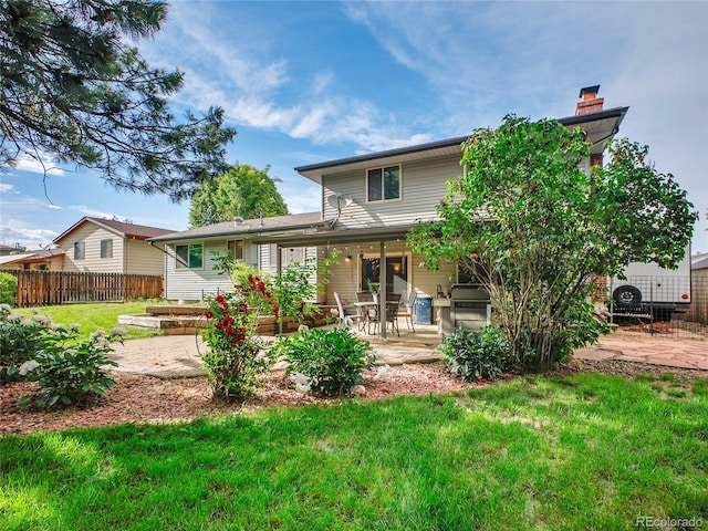 4720 W Stanford Ave, Denver, CO 80236 - back of property with a patio area and a chimney