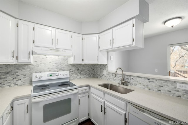kitchen featuring white appliances, under cabinet range hood, a sink, white cabinets, and light countertops