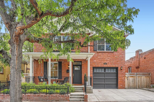 2436 W Argyle Pl, Denver, CO 80211 - view of front facade with a porch, brick siding, an attached garage, and concrete driveway