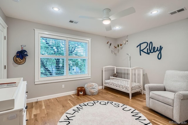 2436 W Argyle Pl, Denver, CO 80211 - bedroom featuring light wood-style floors, a nursery area, baseboards, a ceiling fan, and recessed lighting