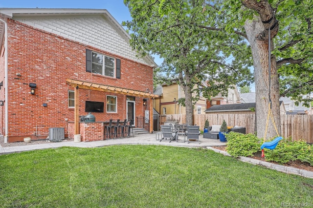2436 W Argyle Pl, Denver, CO 80211 - back of property featuring a patio area, brick siding, and central AC