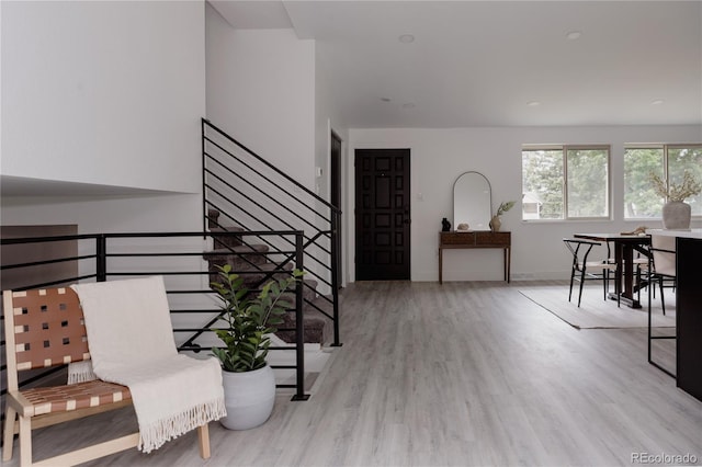 8249 Zephyr St, Arvada, CO 80005 - foyer entrance featuring wood finished floors and stairway