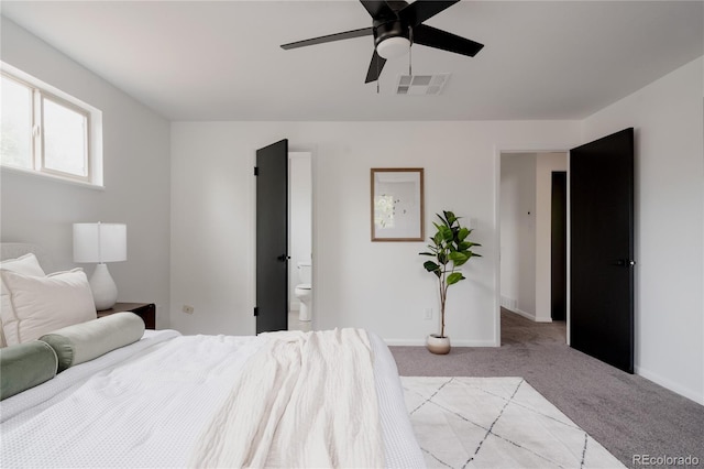 8249 Zephyr St, Arvada, CO 80005 - bedroom with light carpet, ceiling fan, and ensuite bathroom