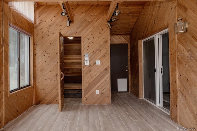 8249 Zephyr St, Arvada, CO 80005 - spare room featuring track lighting, wooden walls, vaulted ceiling, light wood finished floors, and wooden ceiling