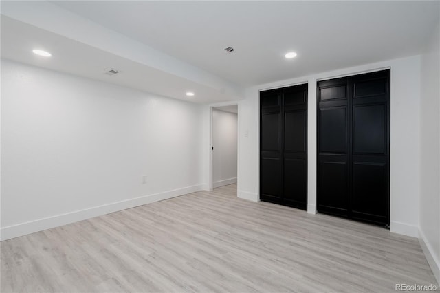 8249 Zephyr St, Arvada, CO 80005 - unfurnished bedroom with light wood-style flooring, recessed lighting, and two closets
