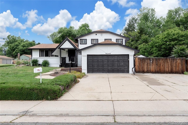 8249 Zephyr St, Arvada, CO 80005 - split level home with concrete driveway, stucco siding, and a garage