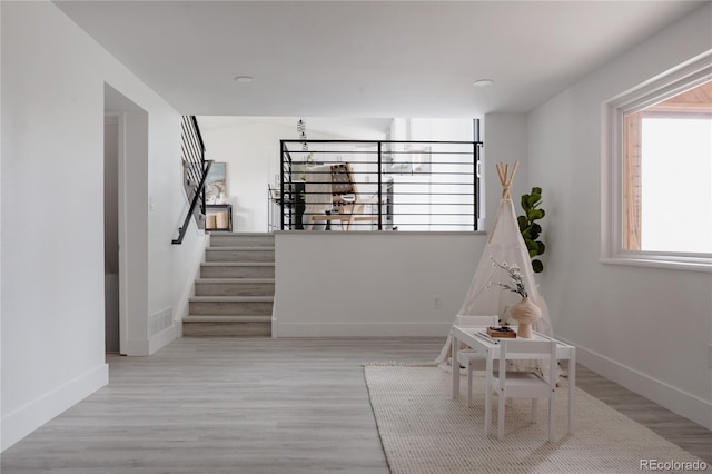 8249 Zephyr St, Arvada, CO 80005 - hall with wood finished floors and stairway