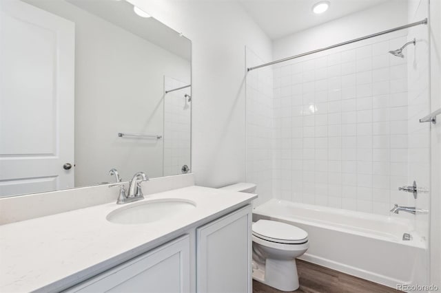 full bathroom with vanity, bathing tub / shower combination, toilet, and wood finished floors