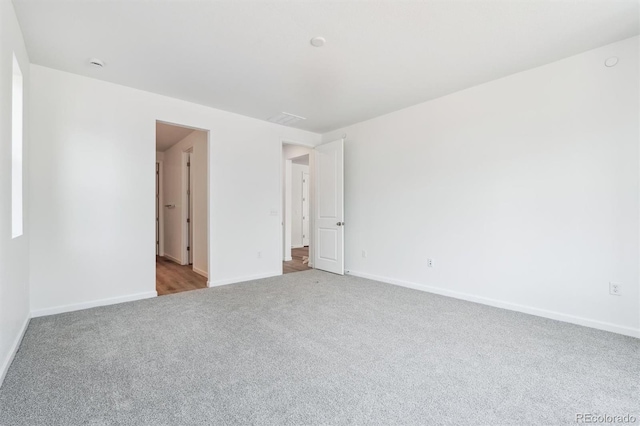 empty room with baseboards and carpet flooring