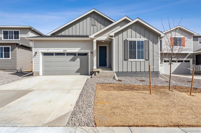 view of front facade featuring board and batten siding, driveway, and a garage