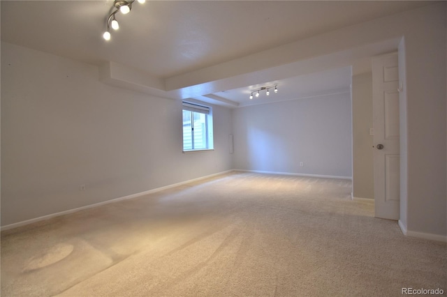 carpeted spare room with track lighting