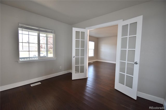 unfurnished room featuring french doors and dark hardwood / wood-style flooring