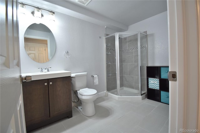 bathroom featuring toilet, walk in shower, vanity, and tile patterned floors