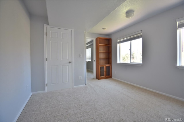 unfurnished bedroom with light carpet