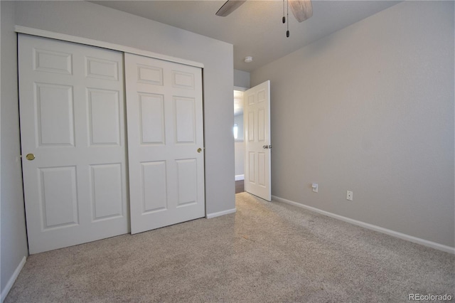 unfurnished bedroom featuring a closet, ceiling fan, and light colored carpet