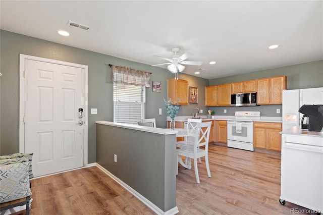 kitchen with a ceiling fan, light wood-style floors, white appliances, light countertops, and visible vents