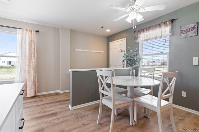 dining area with ceiling fan, a healthy amount of sunlight, and light wood-style floors