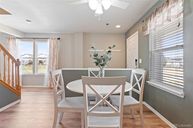 dining room with wood finished floors, stairs, ceiling fan, baseboards, and recessed lighting