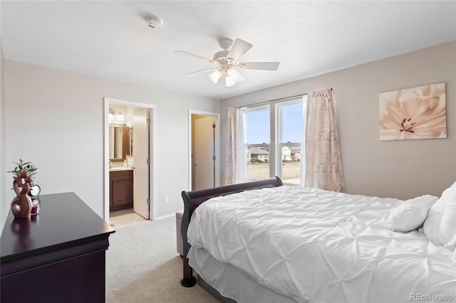 bedroom featuring light colored carpet, baseboards, a ceiling fan, and connected bathroom