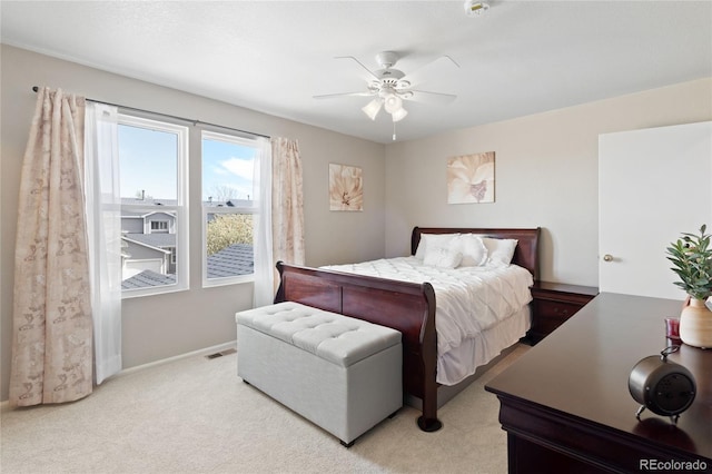 bedroom featuring light carpet, baseboards, visible vents, and ceiling fan