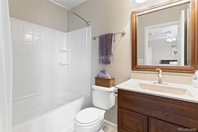 full bath featuring a textured wall, toilet, vanity, and bathing tub / shower combination