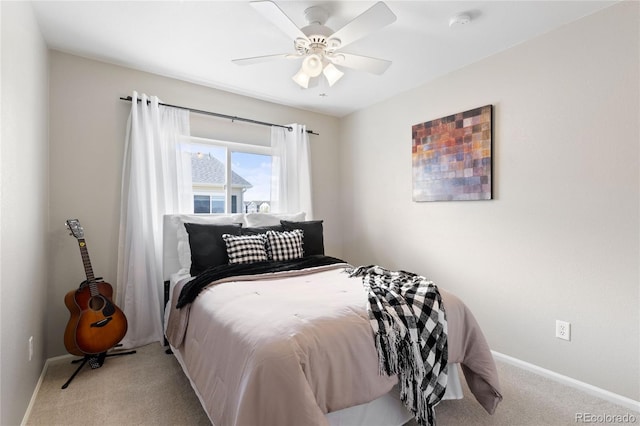 carpeted bedroom featuring baseboards and ceiling fan
