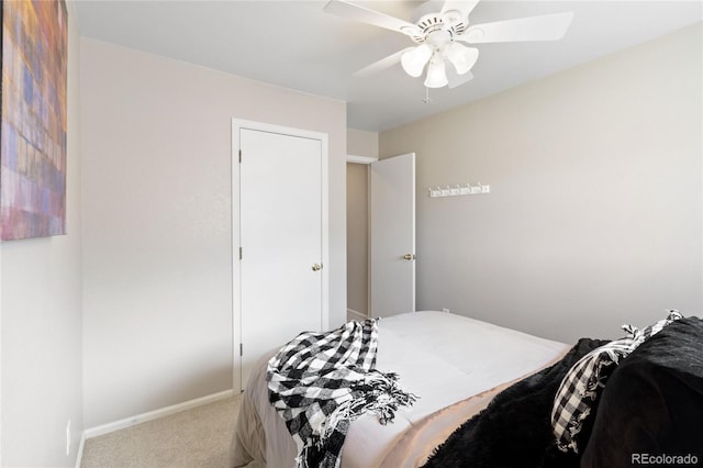 carpeted bedroom with a ceiling fan and baseboards