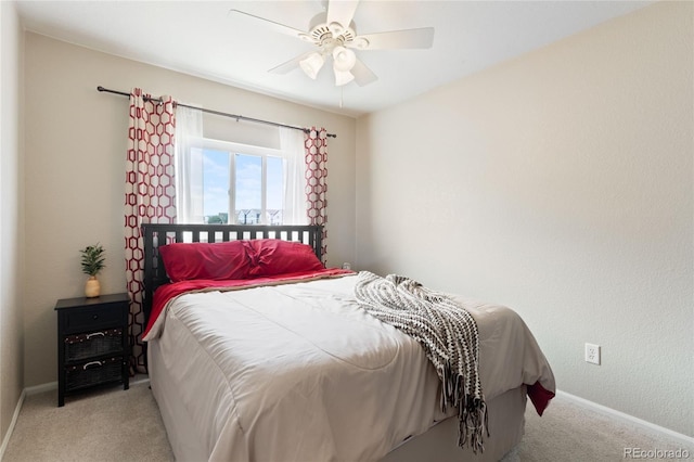carpeted bedroom featuring baseboards and a ceiling fan