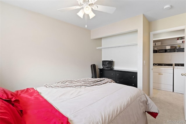 carpeted bedroom featuring independent washer and dryer and a ceiling fan