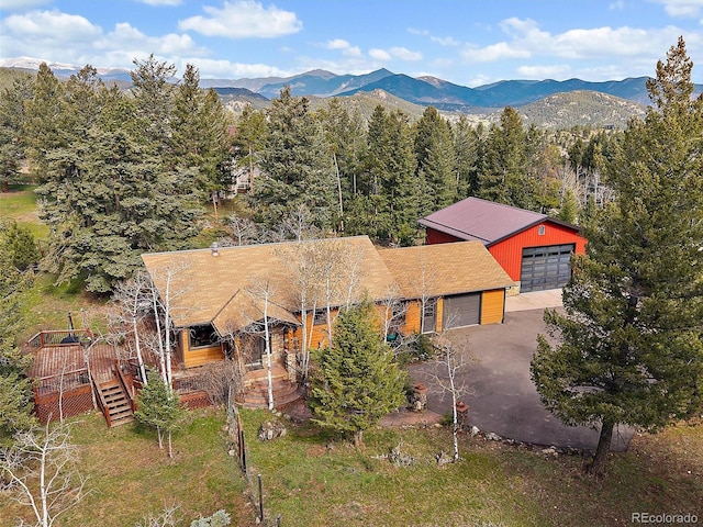 7754 Swaps Trl, Evergreen, CO 80439 - view of subject property with a mountain backdrop and a forest