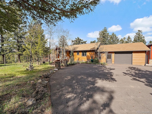 7754 Swaps Trl, Evergreen, CO 80439 - ranch-style home featuring asphalt driveway and an attached garage