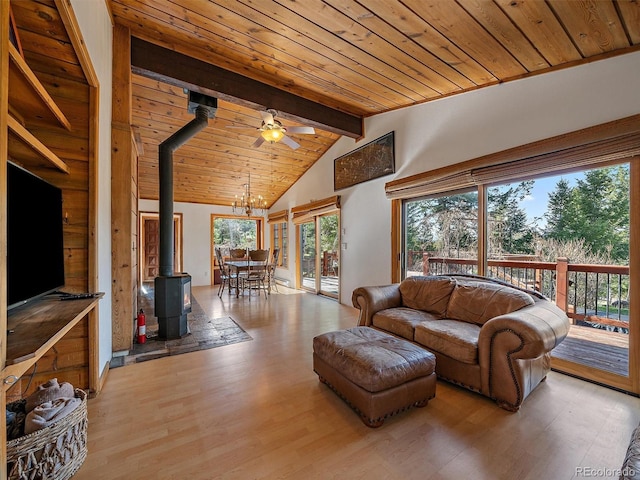 7754 Swaps Trl, Evergreen, CO 80439 - living area with a ceiling fan, a wood stove, wood ceiling, wood finished floors, and a chandelier