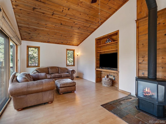 7754 Swaps Trl, Evergreen, CO 80439 - living room with a wood stove, wood ceiling, wood finished floors, built in features, and high vaulted ceiling