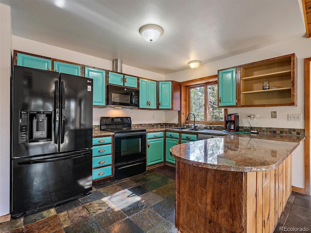 7754 Swaps Trl, Evergreen, CO 80439 - kitchen with black appliances, a peninsula, a sink, stone tile floors, and open shelves