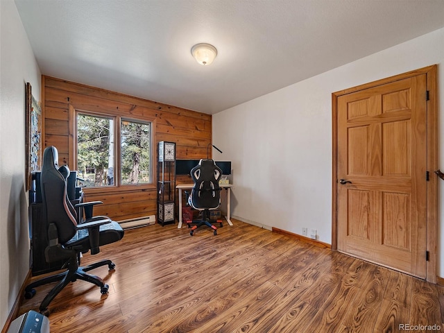 7754 Swaps Trl, Evergreen, CO 80439 - home office featuring wood finished floors, baseboard heating, wood walls, and baseboards