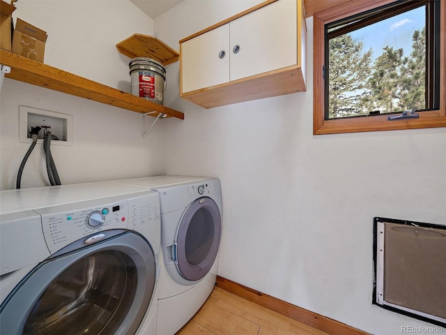 7754 Swaps Trl, Evergreen, CO 80439 - washroom with washer and clothes dryer, cabinet space, baseboards, and light wood-type flooring
