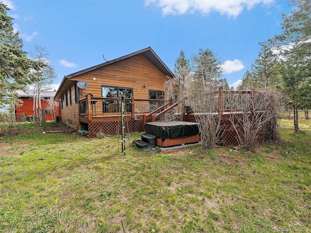 7754 Swaps Trl, Evergreen, CO 80439 - rear view of property featuring a hot tub, a deck, and a yard