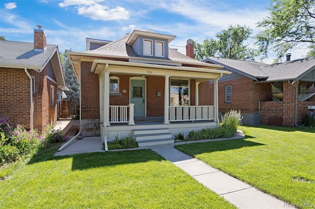 bungalow-style home with a porch and a front lawn